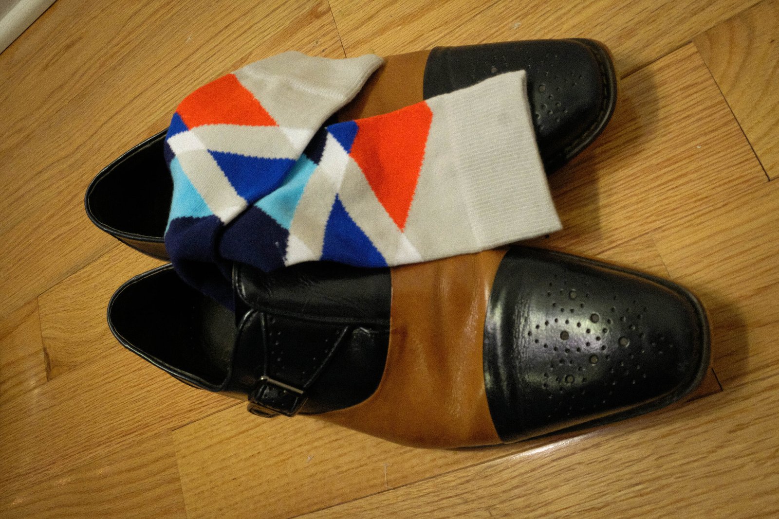 a pair of dress shoes and colorful socks
