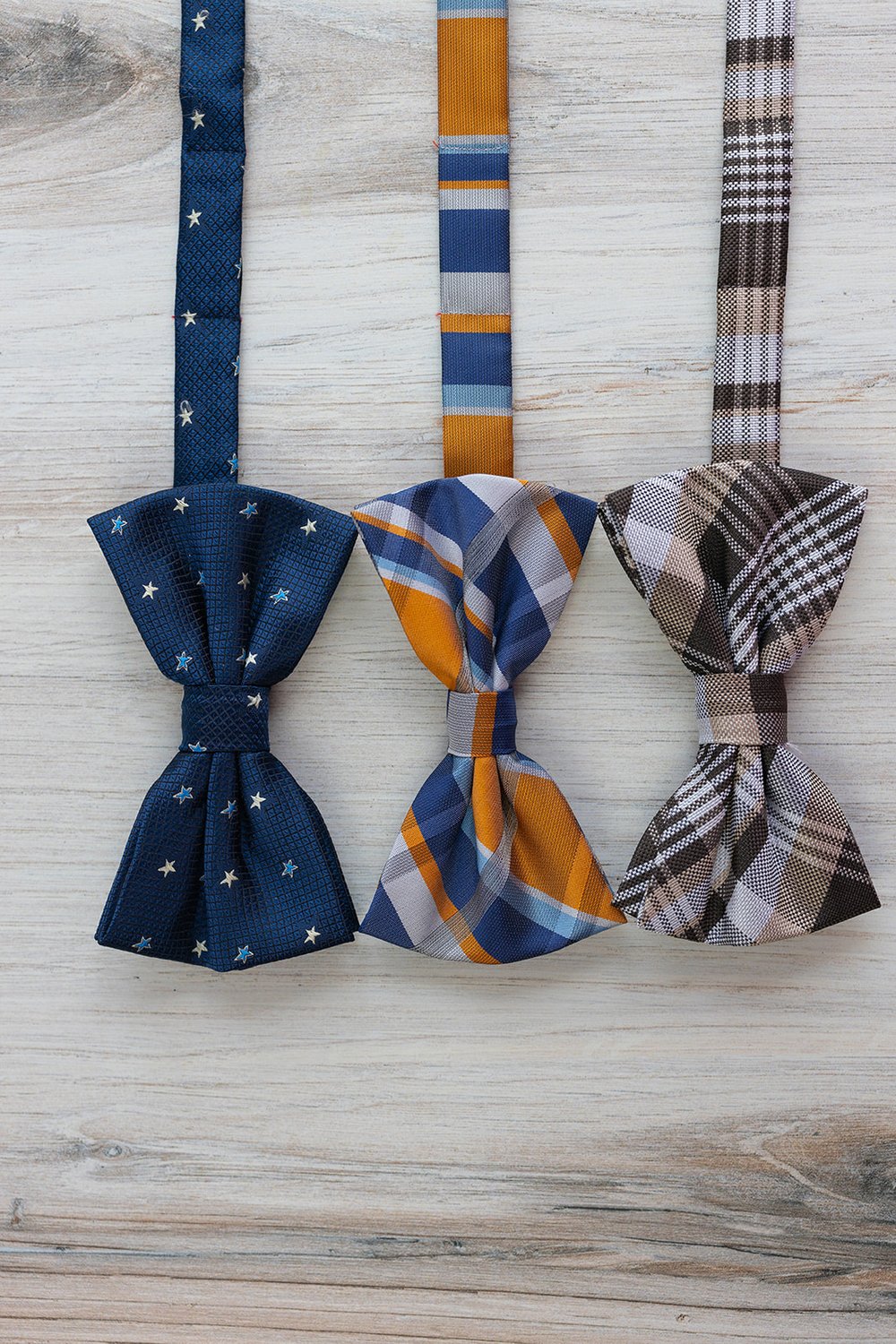 three mens bow ties with different patterns