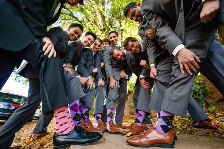a group of executives showing off socks they will donate for someone in need.